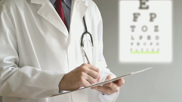 Male ophthalmologist doctor writing prescription to patient