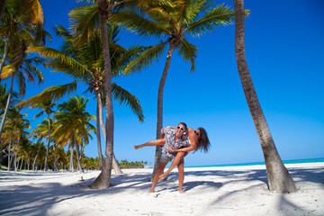 Man giving piggyback ride to girlfriend at the beach