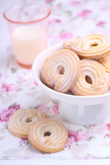 sweet cookies with powdered sugar and a glass of milk