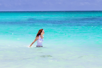 Young beautiful woman swimming in the ocean