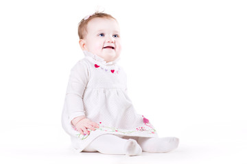 Cute baby girl in a white dress