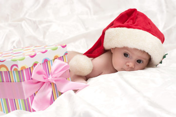 Obraz na płótnie Canvas Christmas little cute girl with Santa hat