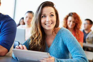 Female University Student Using Digital Tablet In Classroom