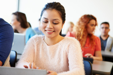 Female University Student Using Digital Tablet In Classroom