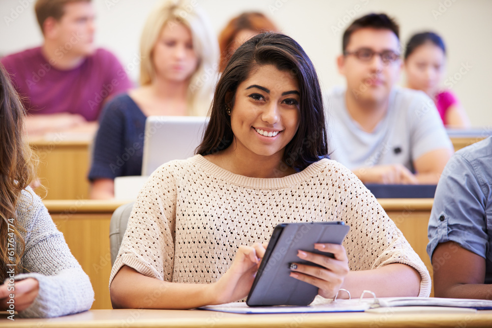 Wall mural female university student using digital tablet in lecture