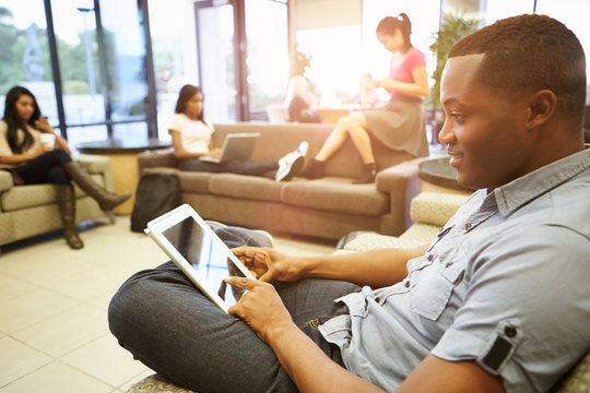 Group Of University Students Relaxing In Common Room