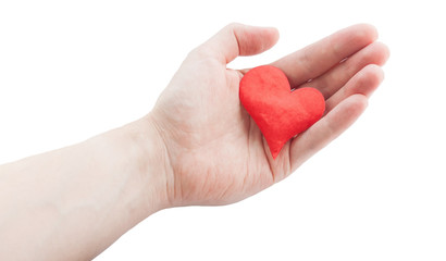 Red cloth heart in hand. Selective focus on heart.