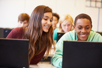 Group Of High School Students In Class Using Laptops