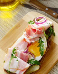 Bacon and fried eggs open sandwich