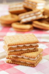 Sandwich cookies on pink tablecloth
