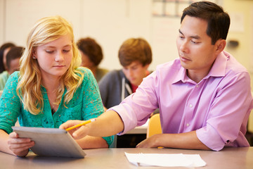 Fototapeta premium High School Student With Teacher Using Digital Tablet