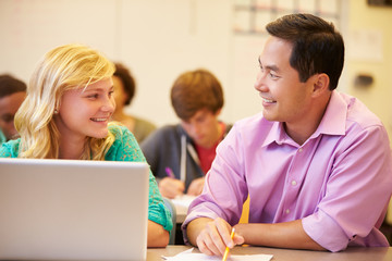 Fototapeta na wymiar High School Student With Teacher In Class Using Laptop