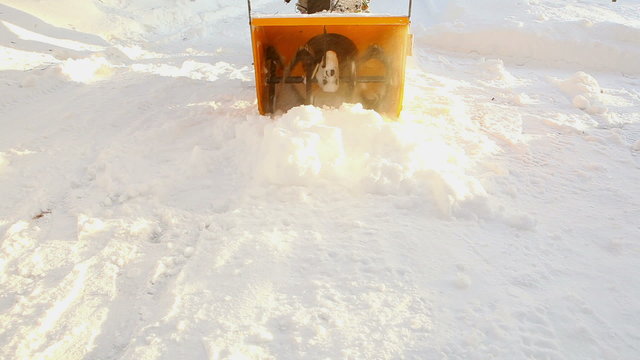 Close-up view of working snow blower