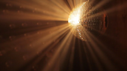 Shiny disco ball with golden reflection and rays in haze, HD 108