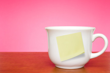 Coffee cup with empty sticky note