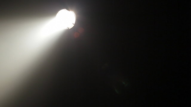 White spotlight moves in the darkness, HD 1080p