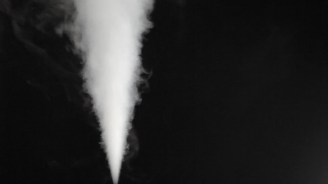 High pressure of white smoke blowing out on black background