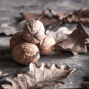 nuts and leaves on wooden table