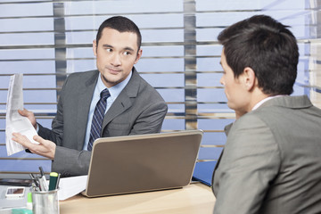 Manager reviewing workers job performance 