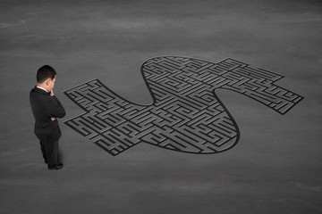 Businessman facing money symbol maze