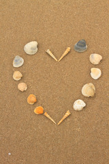 love heart made of shells on beach