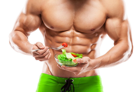 Shaped and healthy body man holding a fresh salad bowl,shaped ab