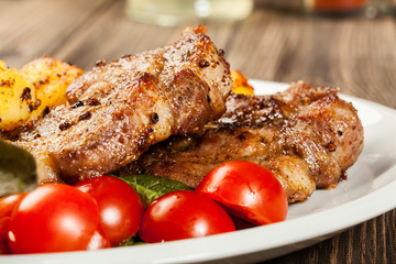 Grilled steaks, baked potatoes and vegetables