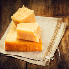Parmesan Cheese on Wooden Background close up. Piece of Parmesan