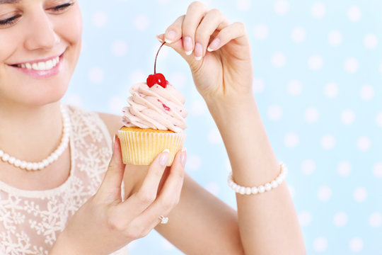 Woman Eating A Cupcake