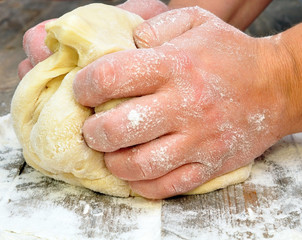 female hand kneads dough