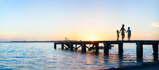Fotobehang Blauwe hemel Family sunset silhouettes  © TravelPhotoBloggers