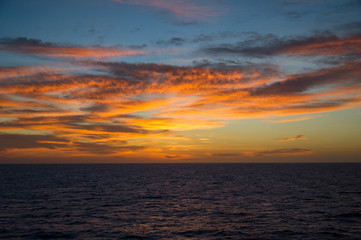 Naklejka na ściany i meble Seascape at sunset with colorful cloudscape