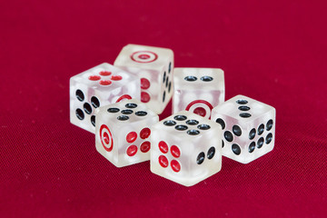 transparent dice on a red felt