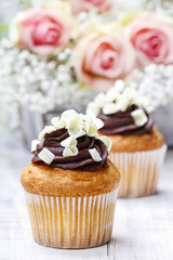 Chocolate cupcakes for wedding reception. Bouquet of pink roses