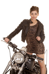 Naklejka na ściany i meble woman leopard dress jacket stand on motorcycle look