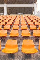 Columns of orange plastic stadium seats
