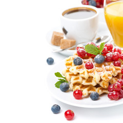 delicious breakfast with waffles, berries, orange juice