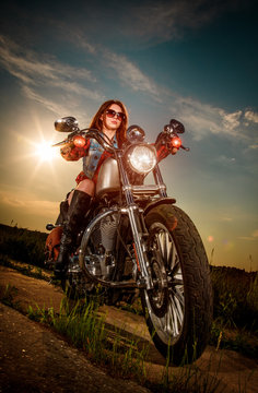Biker girl sitting on motorcycle