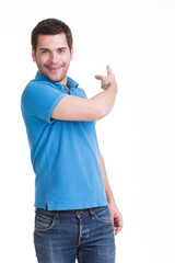 Young happy man shows a finger.