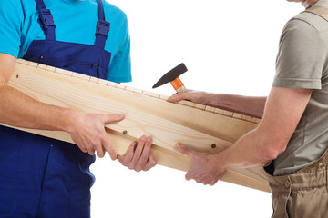 Builders holding timber