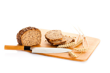 Loaf of wholemeal bread  cutting into slices on wood bread board