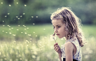 Portrait of a young girl on a meadow