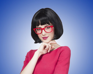 Brunette girl in glasses at  blue background.