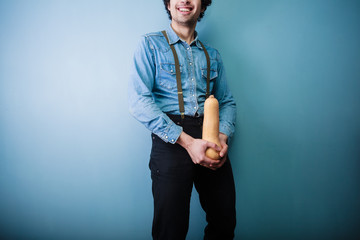 Happy young farmer holding a squash