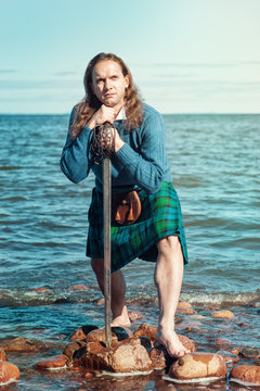 Scottish man with sword at the sea