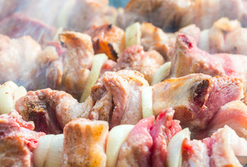 crude meat is fried on coals