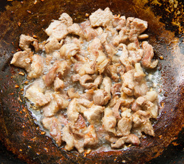 Pork fried in a pan