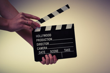 Movie flapper in woman´s hands on white background