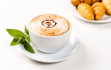 large cup of coffee and croissants on a plate