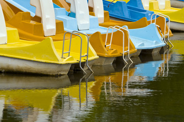 Fototapeta na wymiar Paddle boats reflection